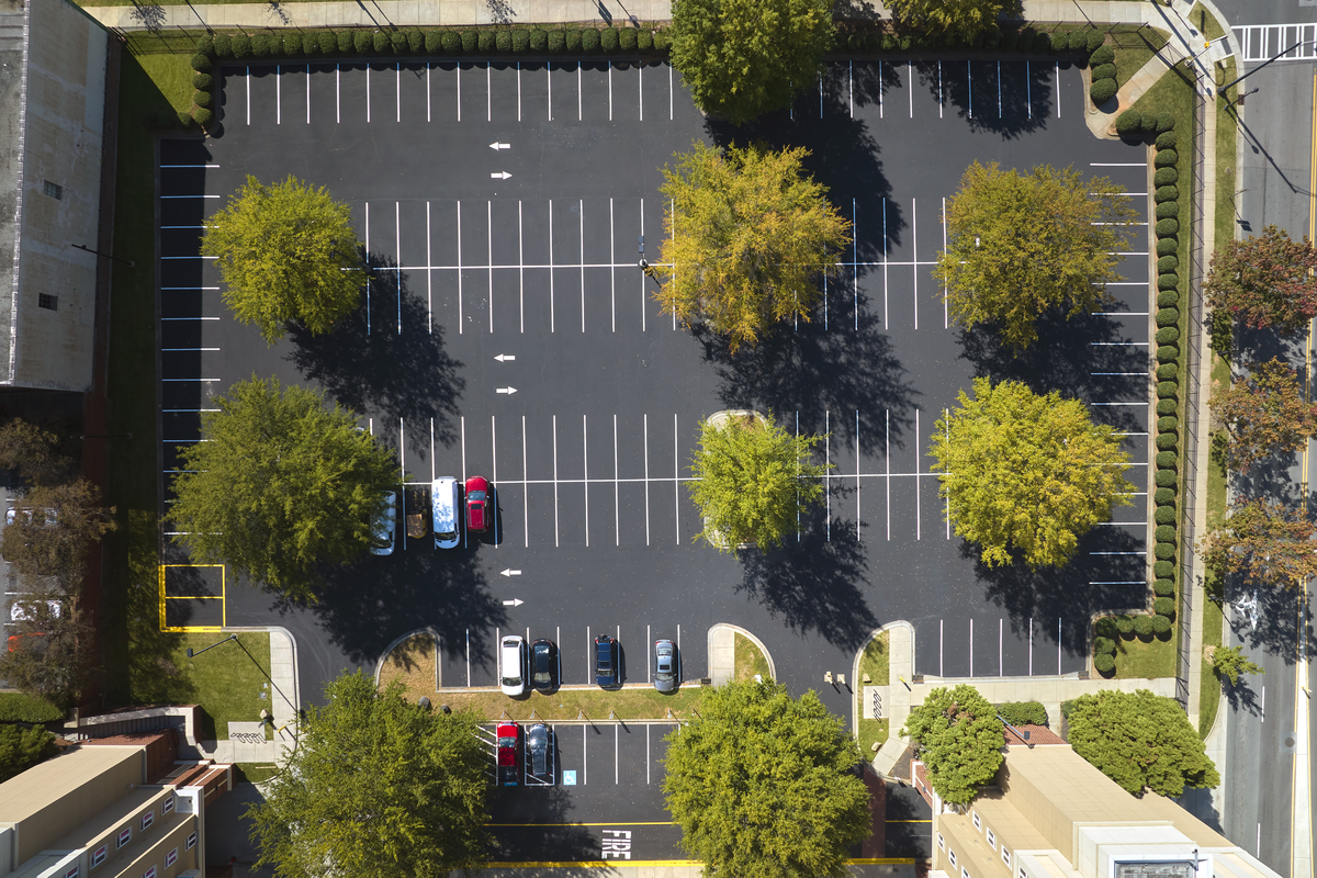 aerial view of many colorful cars parked on parking lot